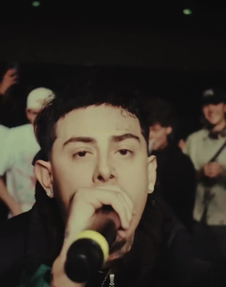 Southside Hoodlum performing at the microphone, crowd behind him